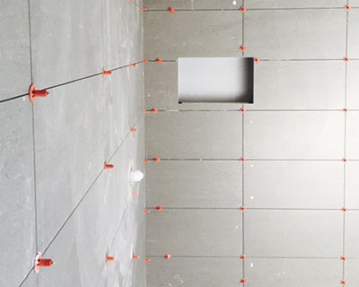 Tiles held in place with the ATR Tile Leveling system while adhesive dries