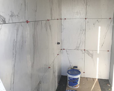 Large format marble tiles look great in this work-in-progress wall installation using the ATR Tile Leveling system